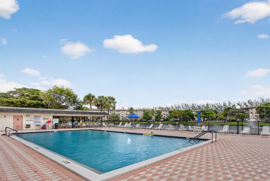 1801 Eleuthera Point, Unit D3 Coconut Creek, FL 33066 - Photo 42 of 80 a view of a swimming pool and trees in the back