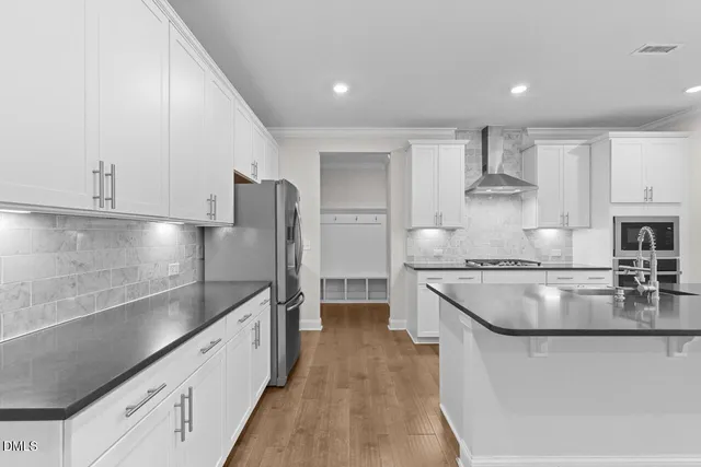 a kitchen with stainless steel appliances granite countertop a stove a sink and a refrigerator