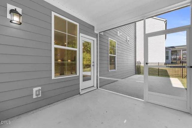 a bedroom with a bed and a large window with balcony view