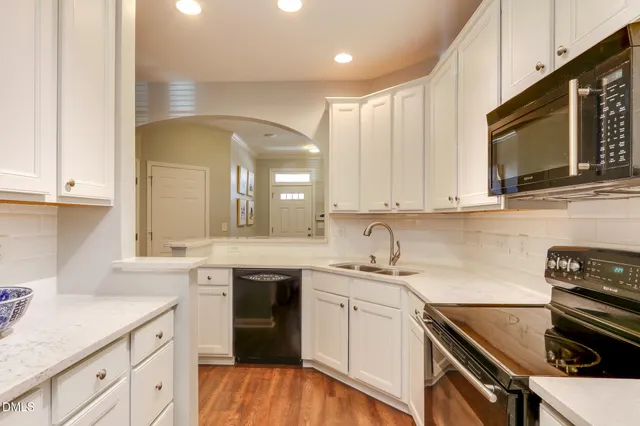 a kitchen with a sink stove and cabinets