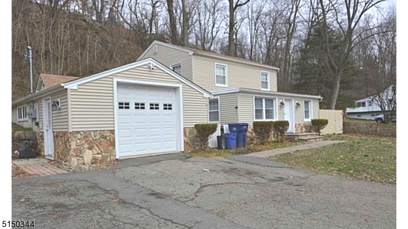 119 Green Pond Road Rockaway, NJ 07866 - Photo 1 of 14 a view of a house with a yard and a large tree