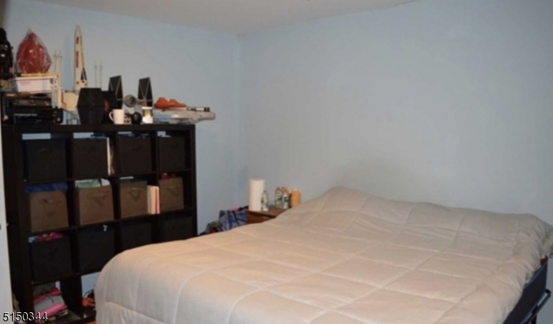 119 Green Pond Road Rockaway, NJ 07866 - Photo 3 of 14 a bedroom with a bed and a desk