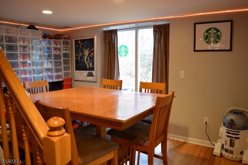 119 Green Pond Road Rockaway, NJ 07866 - Photo 4 of 14 a dining room with a table and chairs with wooden floor