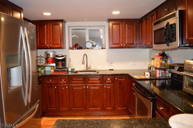 119 Green Pond Road Rockaway, NJ 07866 - Photo 5 of 14 a kitchen with stainless steel appliances granite countertop a refrigerator and a sink