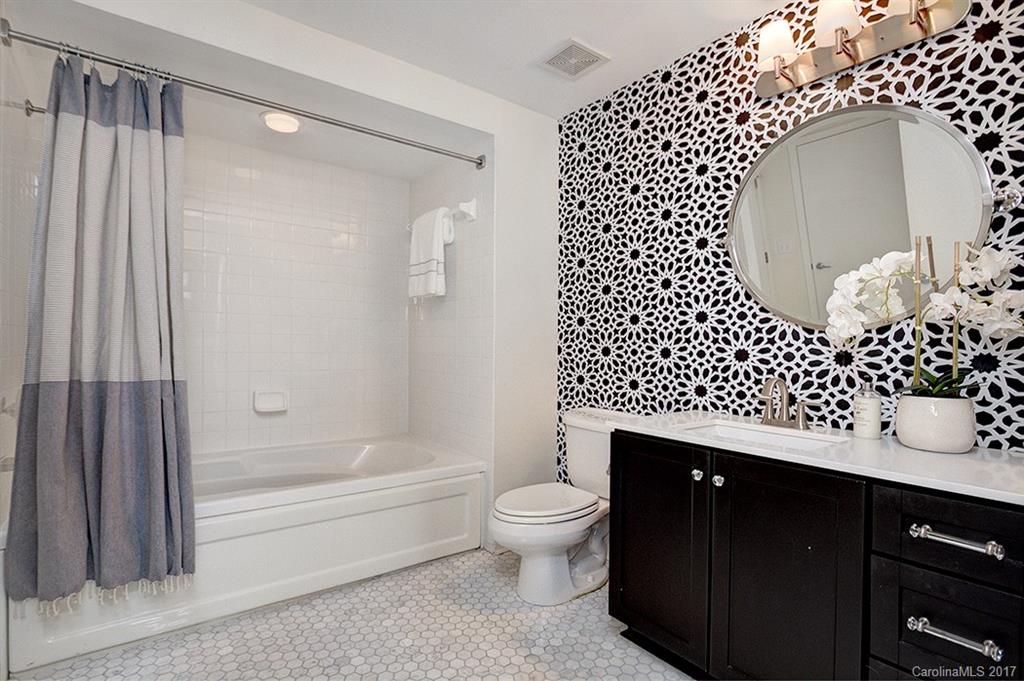 3920 Sharon Road, Unit 206 Charlotte, NC 28211 - Photo 16 of 24 a bathroom with a sink a toilet and shower