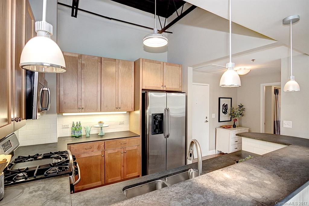 3920 Sharon Road, Unit 206 Charlotte, NC 28211 - Photo 5 of 24 a kitchen with stainless steel appliances granite countertop a refrigerator a sink and a stove