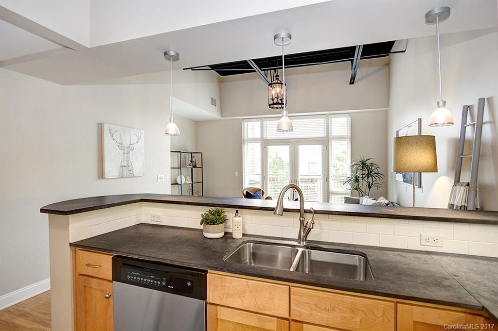 3920 Sharon Road, Unit 206 Charlotte, NC 28211 - Photo 6 of 24 a kitchen with a sink and a refrigerator