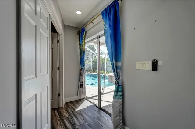 a view of hallway with wooden floor and front door