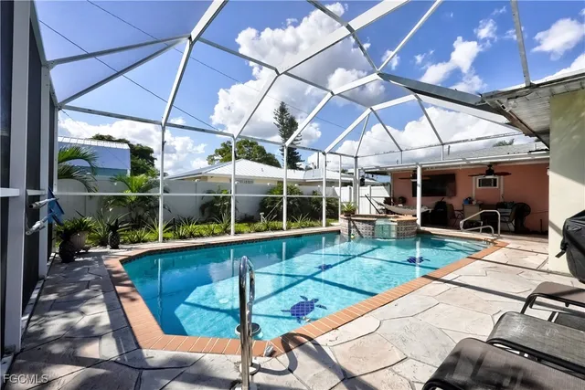 a view of a backyard with table and chairs under an umbrella