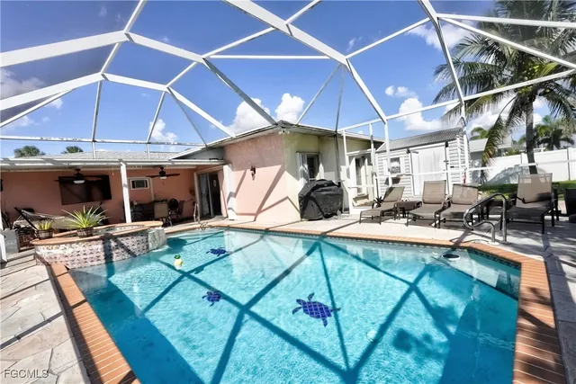a view of a patio with table and chairs under an umbrella
