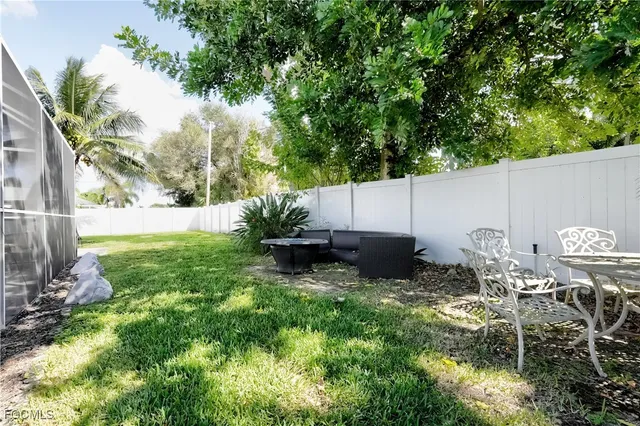 a backyard of a house with table and chairs