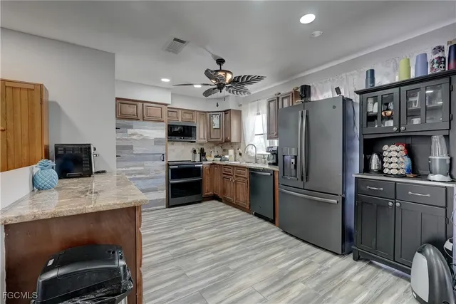 a kitchen with refrigerator cabinets and wooden floor