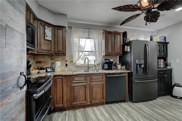 a kitchen with stainless steel appliances granite countertop a stove top oven a sink and dishwasher