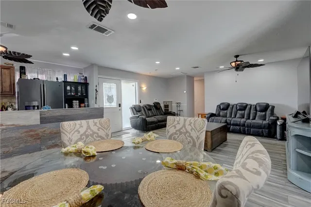 a living room with furniture and a view of kitchen