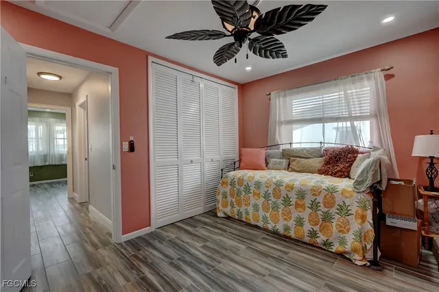 a spacious bedroom with a bed and a chandelier