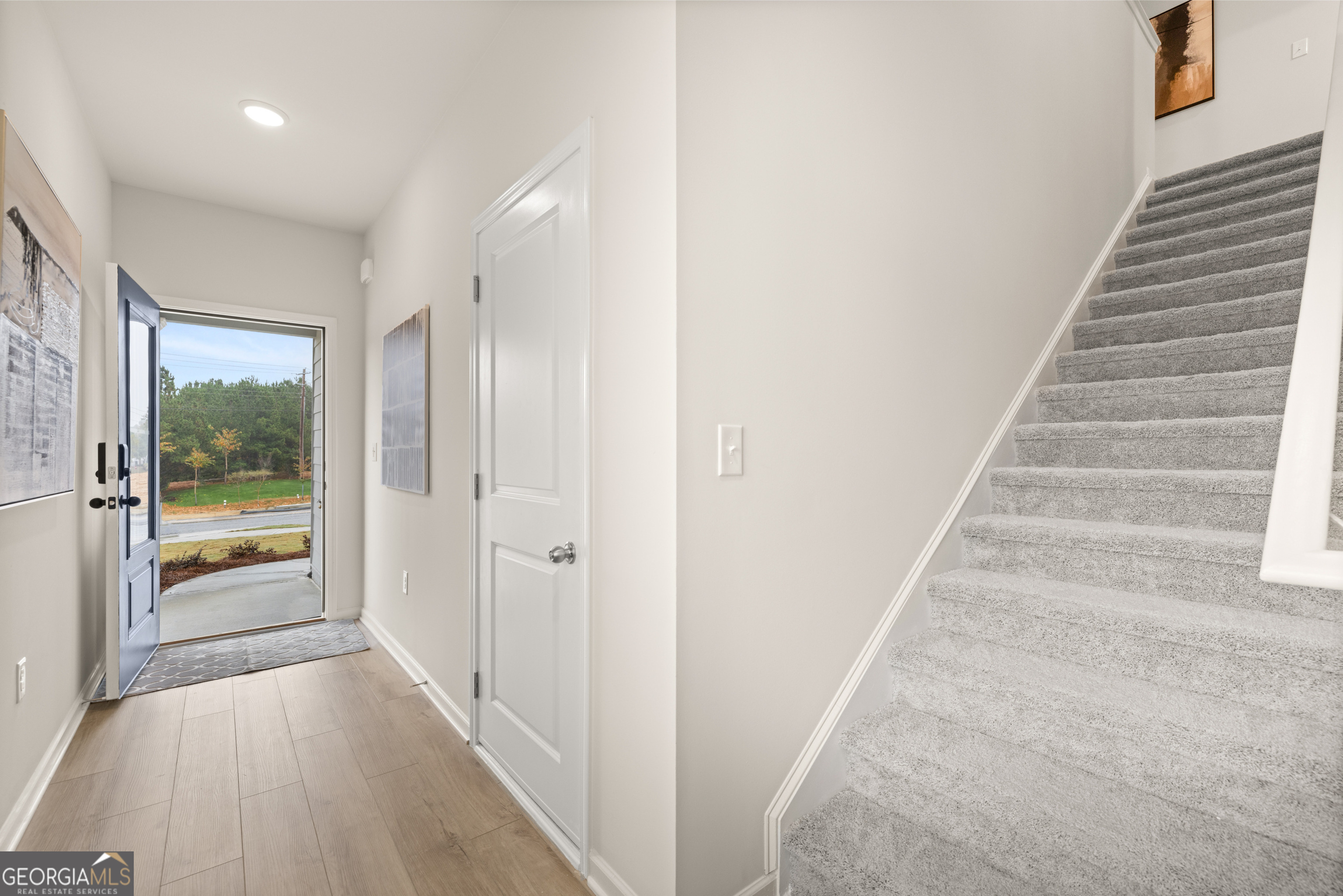 1042 Merritt Drive, Unit 22 Villa Rica, GA 30180 - Photo 5 of 24 a view of a hallway with wooden floor and windows