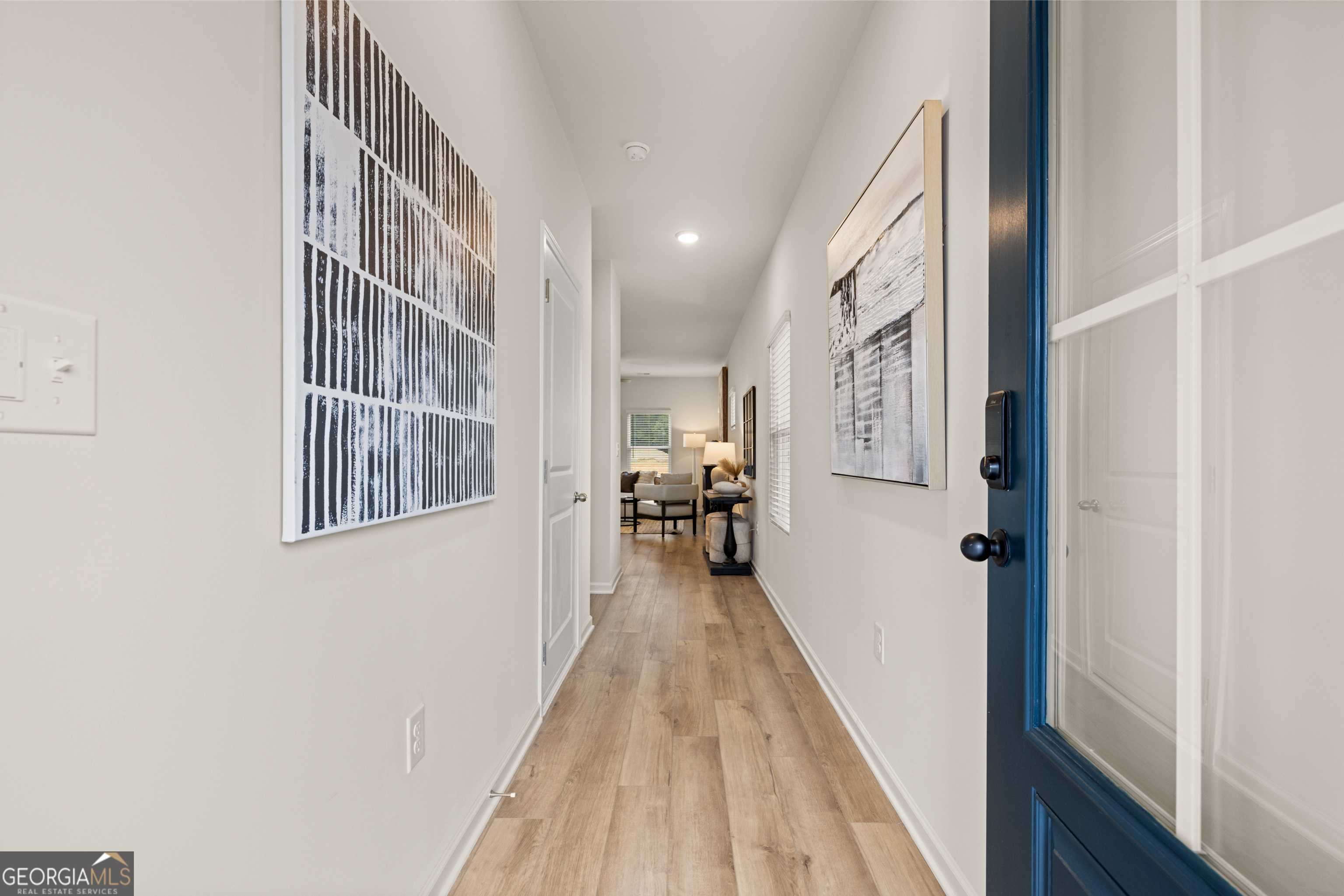 1042 Merritt Drive, Unit 22 Villa Rica, GA 30180 - Photo 6 of 24 a view of a hallway with wooden floor and staircase