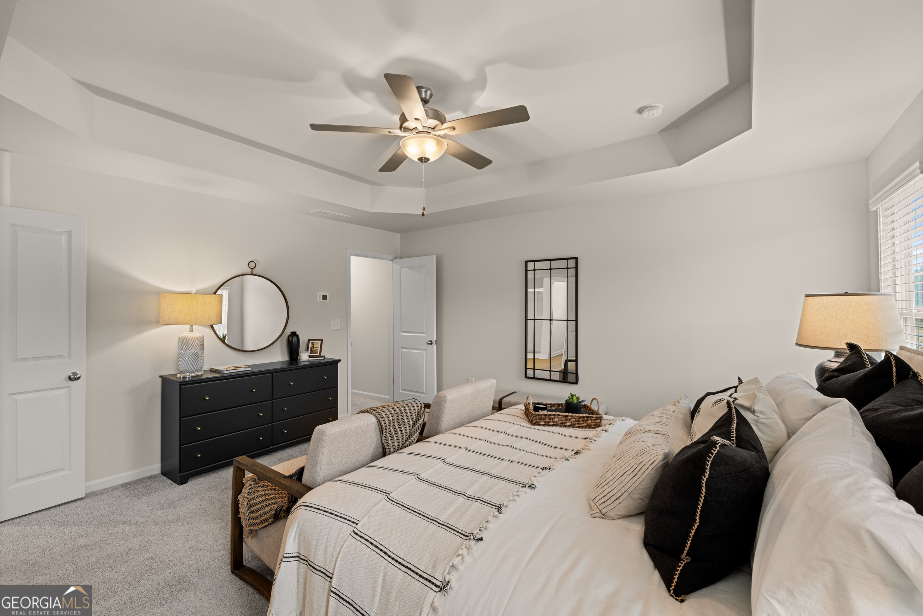 1042 Merritt Drive, Unit 22 Villa Rica, GA 30180 - Photo 7 of 24 a bedroom with a bed window and a chandelier