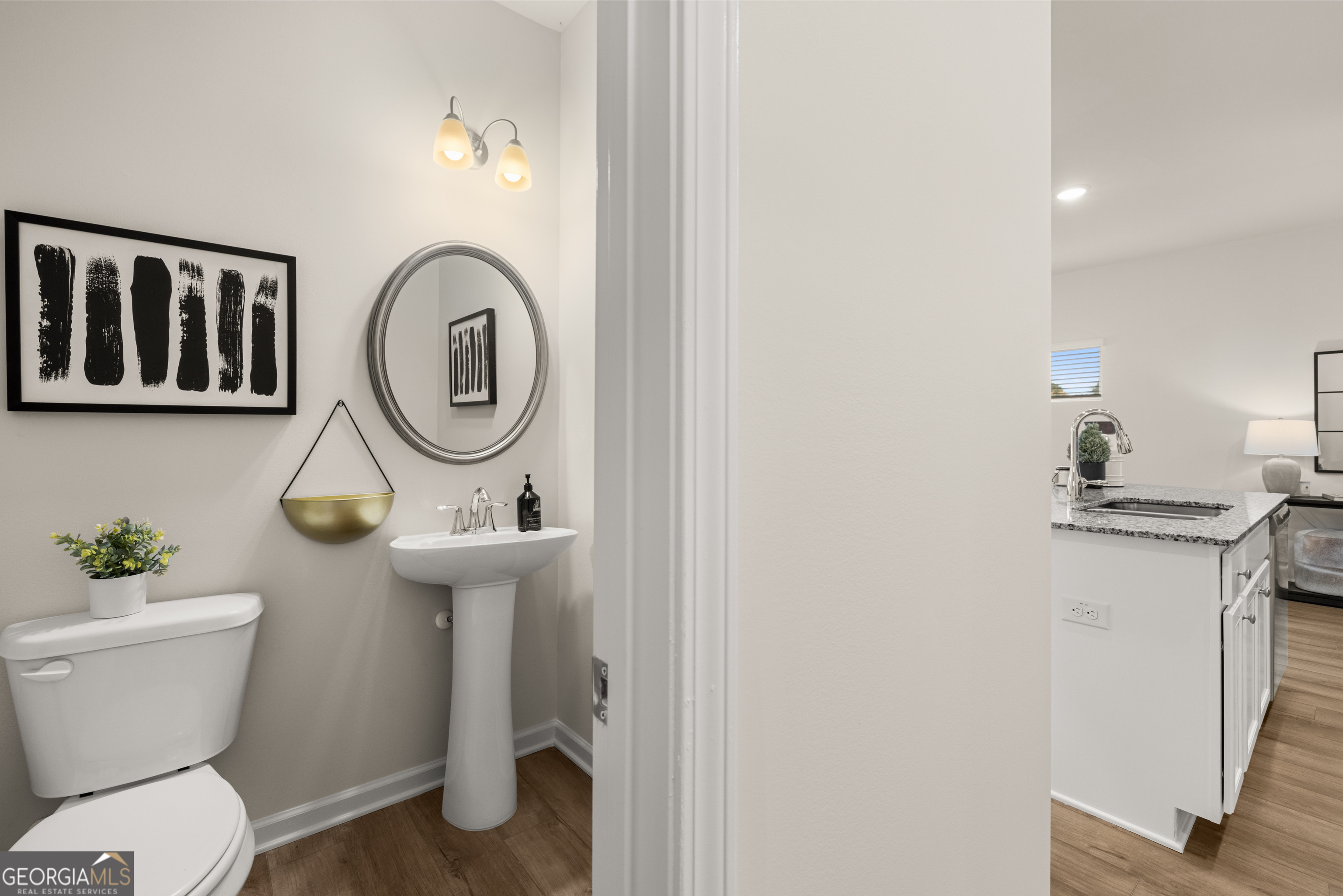 1042 Merritt Drive, Unit 22 Villa Rica, GA 30180 - Photo 10 of 24 a bathroom with a toilet a sink and a mirror