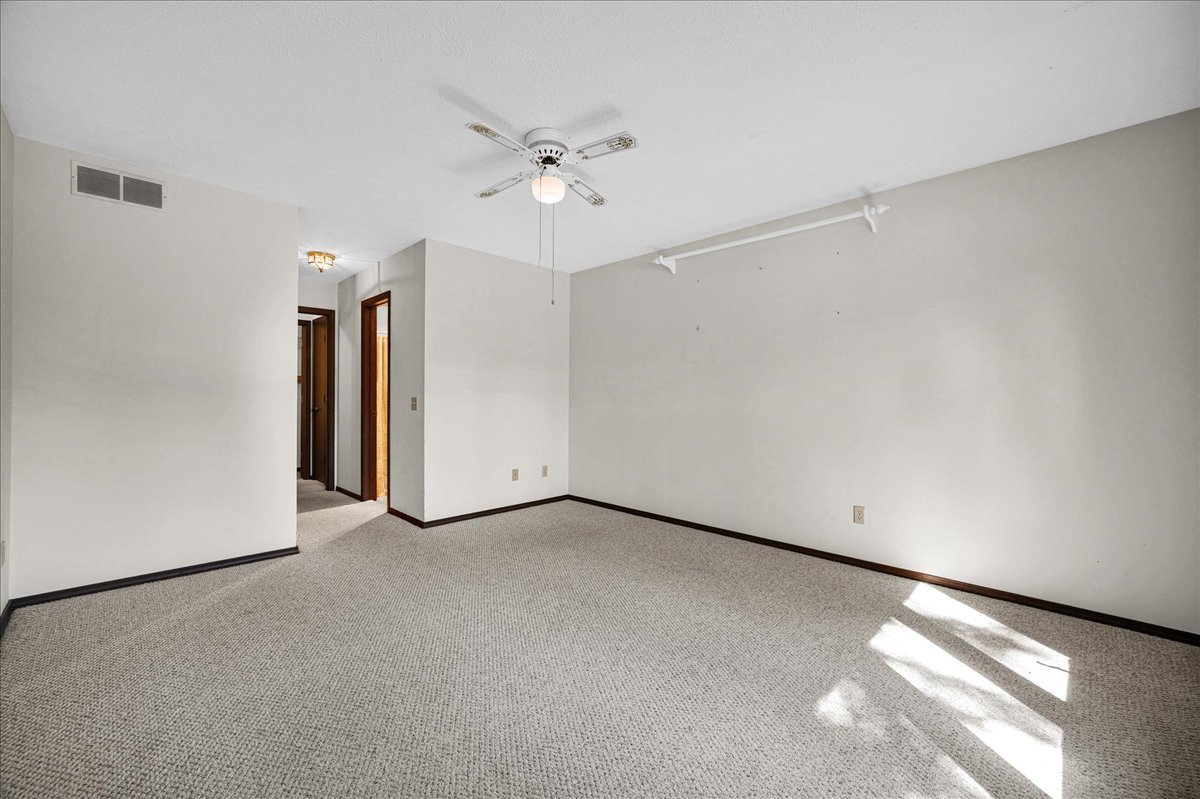 1509 Fort Jesse Road, Unit 13 Normal, IL 61761 - Photo 15 of 30 an empty room with a ceiling fan and a window