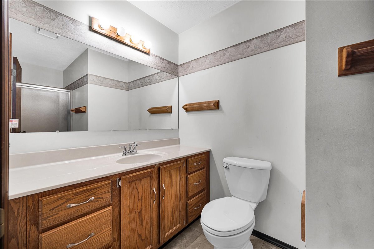 1509 Fort Jesse Road, Unit 13 Normal, IL 61761 - Photo 17 of 30 a bathroom with a granite countertop sink a toilet and a mirror