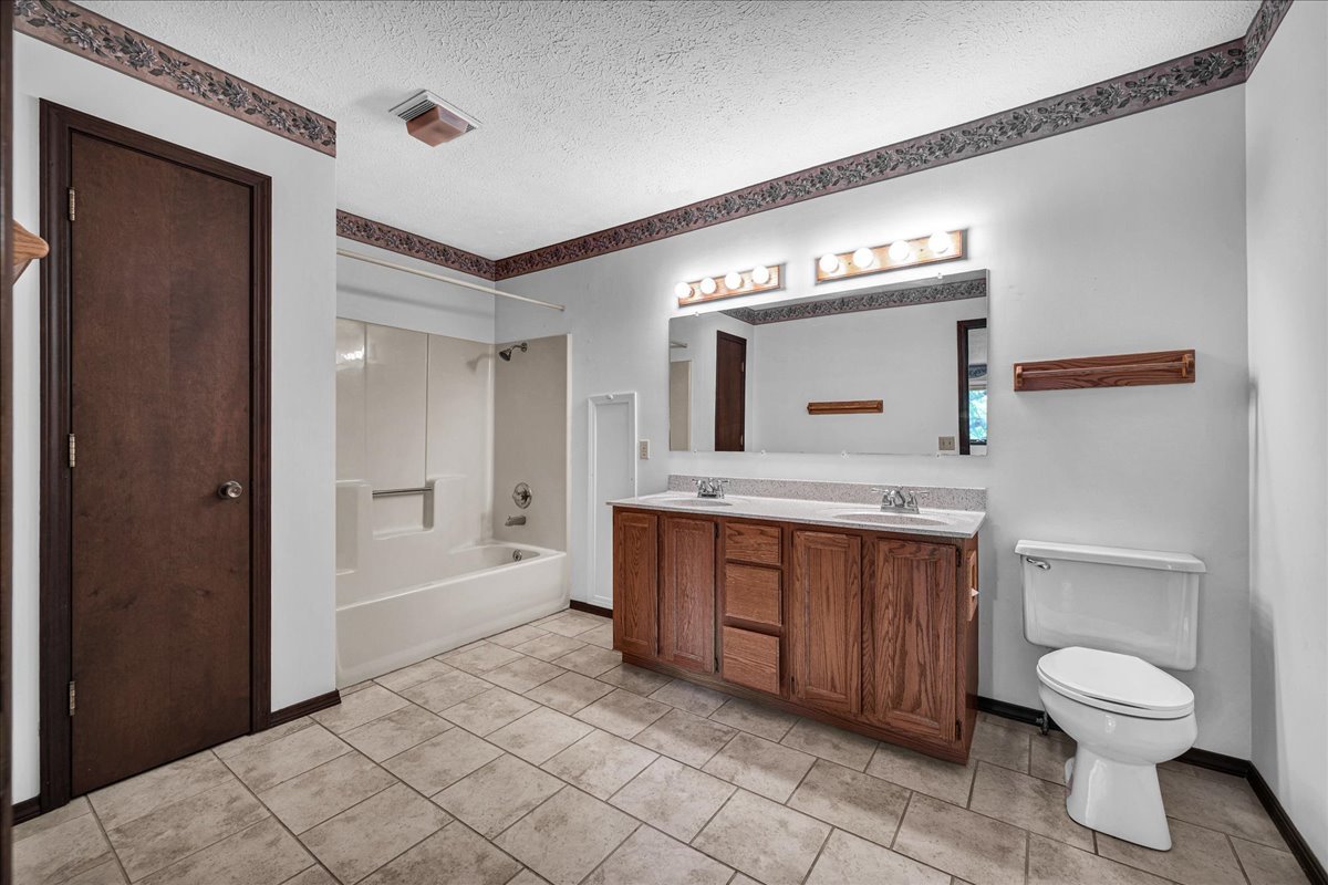 1509 Fort Jesse Road, Unit 13 Normal, IL 61761 - Photo 21 of 30 a spacious bathroom with a toilet sink and mirror