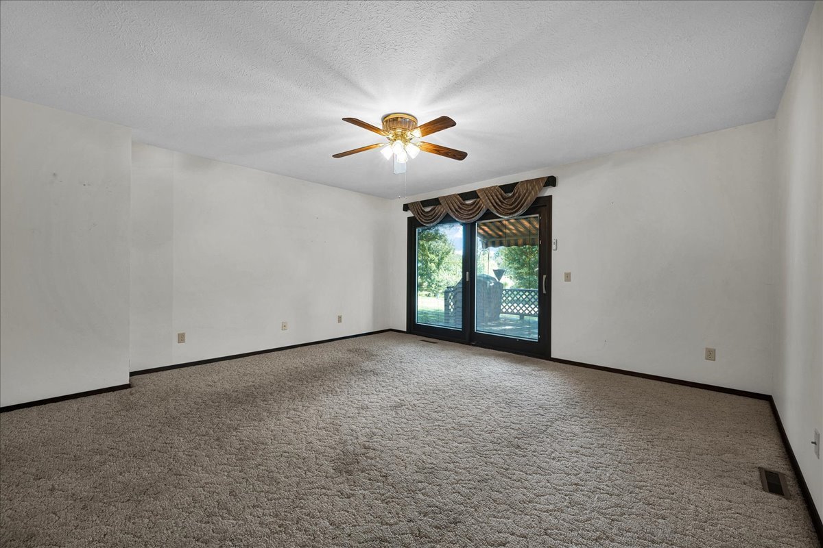 1509 Fort Jesse Road, Unit 13 Normal, IL 61761 - Photo 6 of 30 an empty room with a window and a ceiling fan