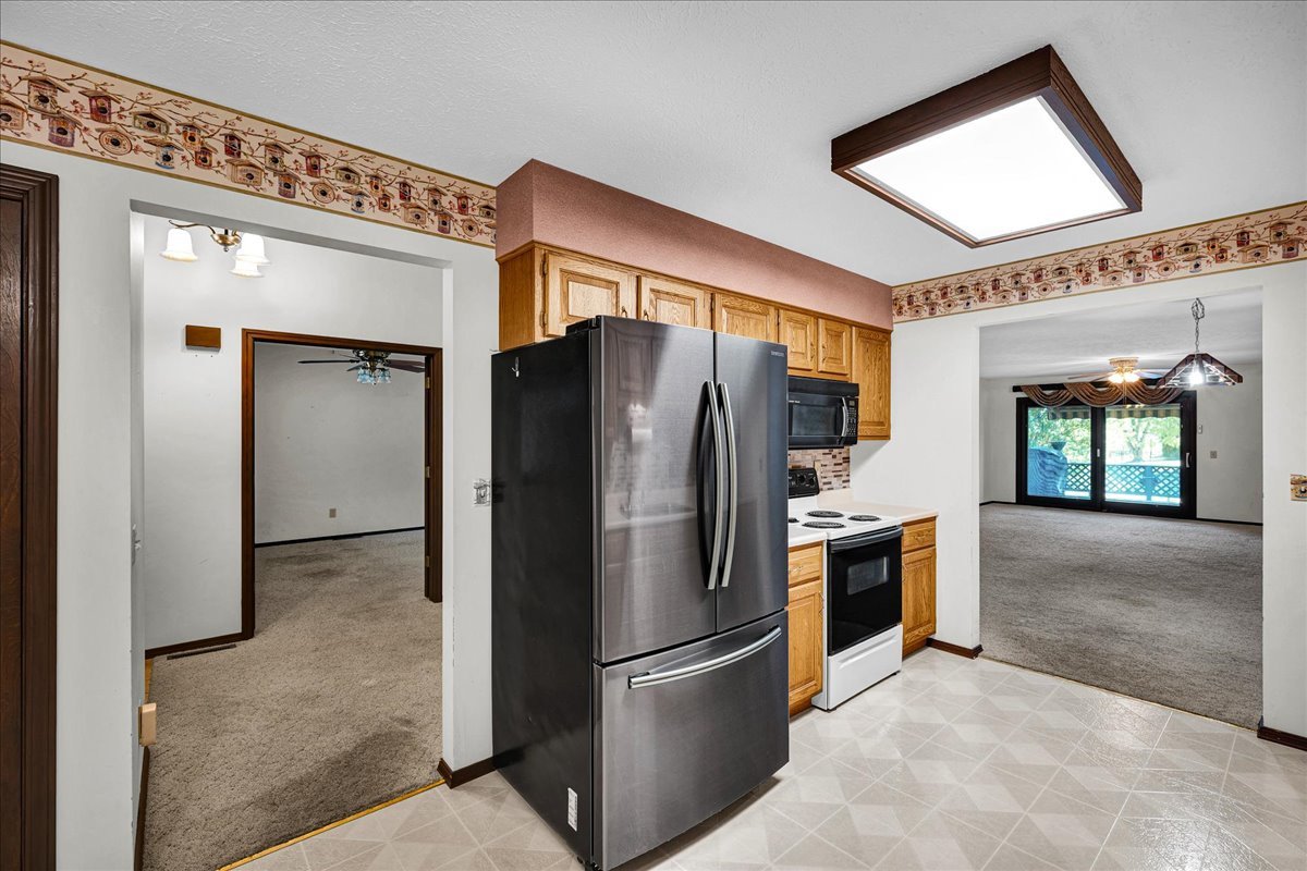 1509 Fort Jesse Road, Unit 13 Normal, IL 61761 - Photo 10 of 30 a kitchen with stainless steel appliances granite countertop a refrigerator and a stove top oven