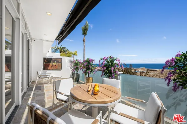 a outdoor dining space with furniture and a potted plant