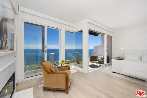 a bedroom with furniture and a large window