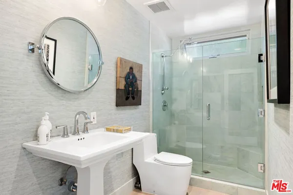 a bathroom with a sink toilet and shower