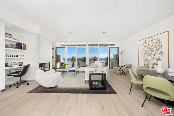 a living room with furniture a rug and a large window