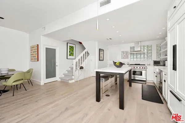 a living room with furniture a wooden floor and next to a window