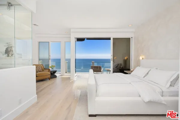 a bedroom with a bed and a couch
