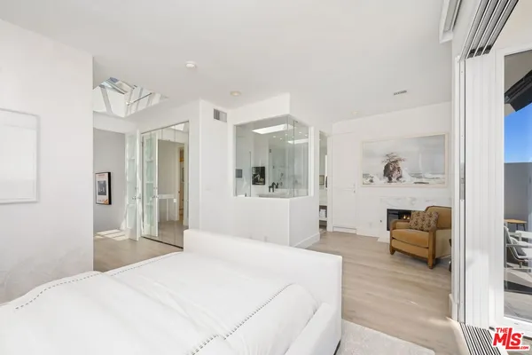 a bedroom with a bed and a painting on the wall