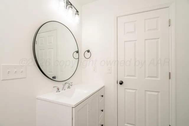 a bathroom with a sink a mirror and a shower