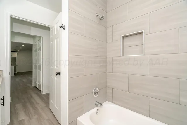 a bathroom with a tub and shower