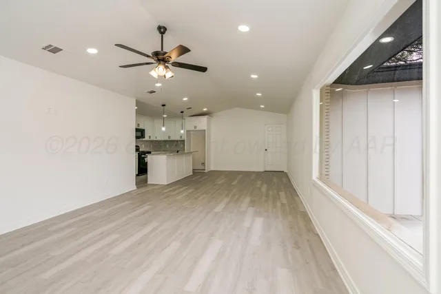a view of a kitchen with a sink and refrigerator