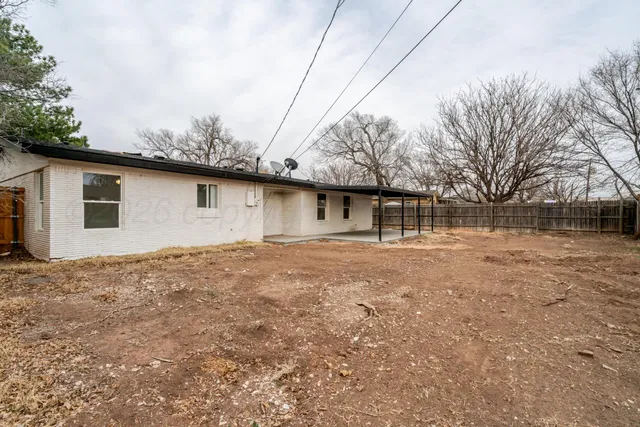 a backyard of a house with large trees