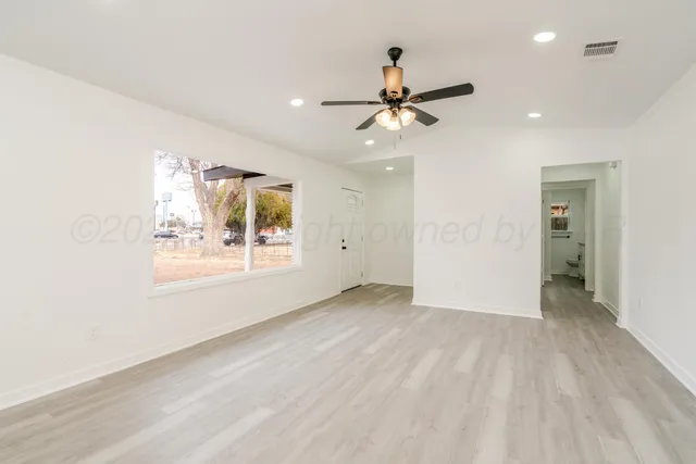 a view of an empty room with a window