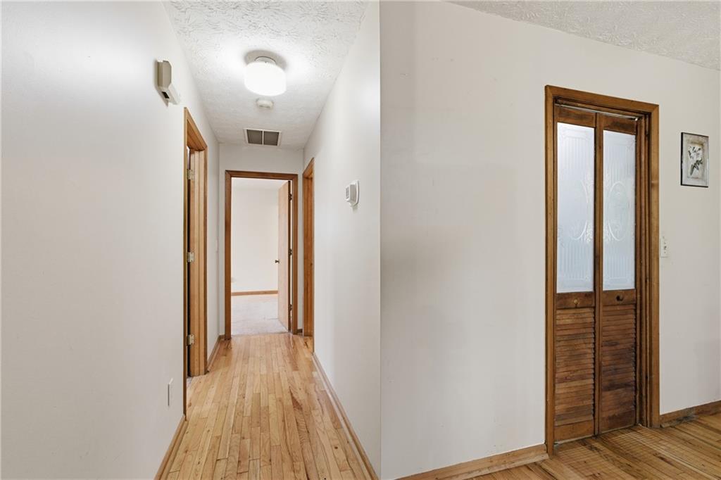 143 Copperhead Road Cornelia, GA 30531 - Photo 12 of 56 a view of a hallway with wooden floor