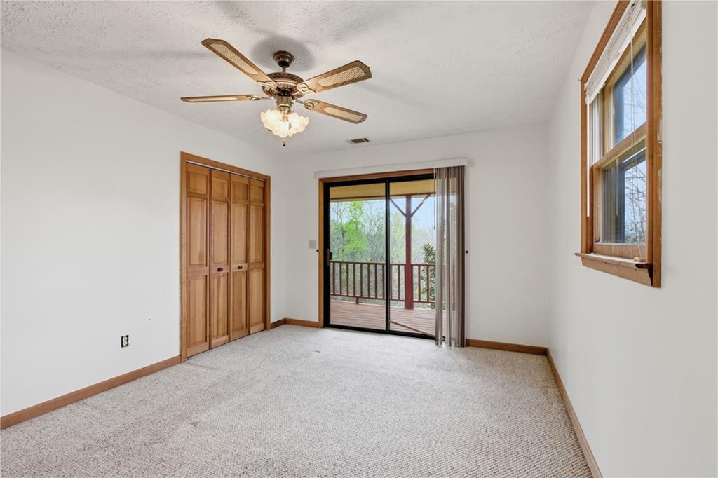 143 Copperhead Road Cornelia, GA 30531 - Photo 14 of 56 a view of a livingroom with a ceiling fan & windows