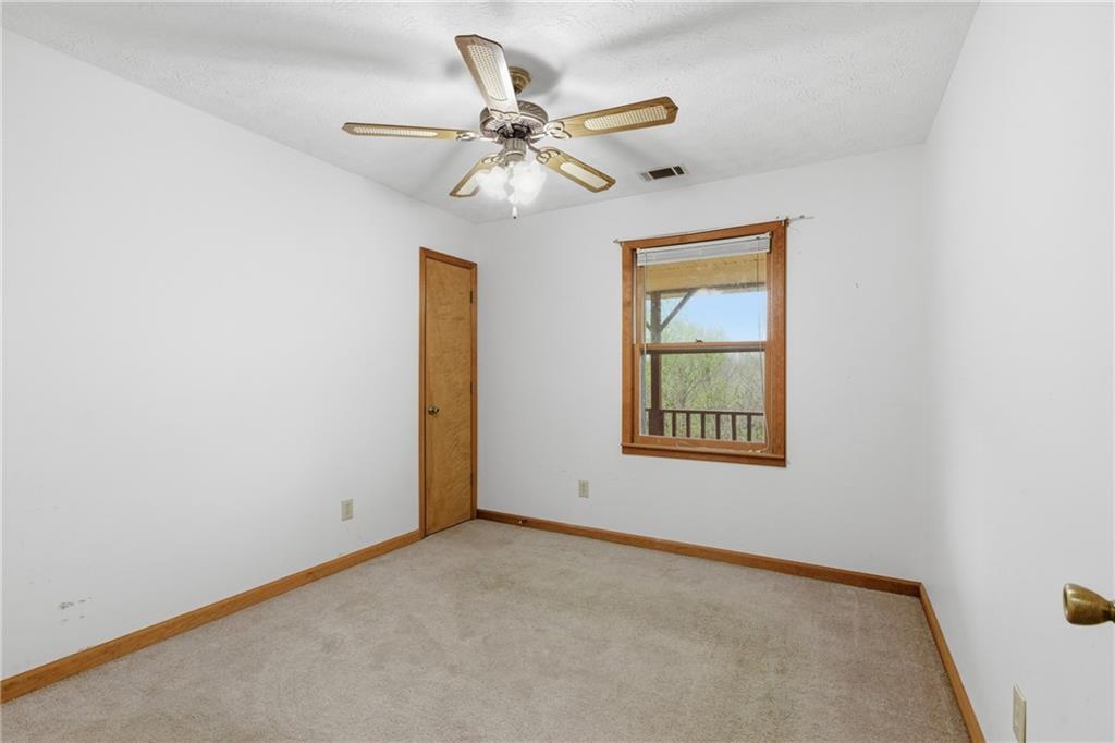 143 Copperhead Road Cornelia, GA 30531 - Photo 18 of 56 an empty room with a window and a fan