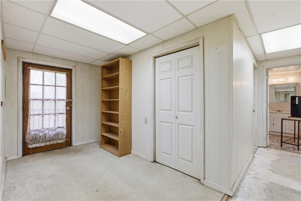 143 Copperhead Road Cornelia, GA 30531 - Photo 31 of 56 an empty room with a cabinet and mirrors