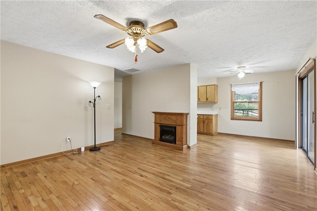 143 Copperhead Road Cornelia, GA 30531 - Photo 4 of 56 an empty room with windows fireplace and wooden floor