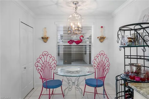 a view of a dining room with furniture and a chandelier