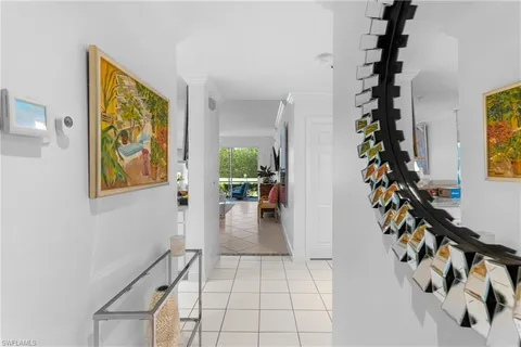 a view of entryway with paintings on the wall