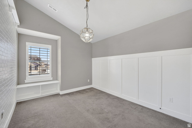 14714 South Bright Wood Road Herriman, UT 84096 - Photo 26 of 41 Carpeted bedroom 2 with lofted ceiling, brick wall, a wainscoted wall, and a decorative wall