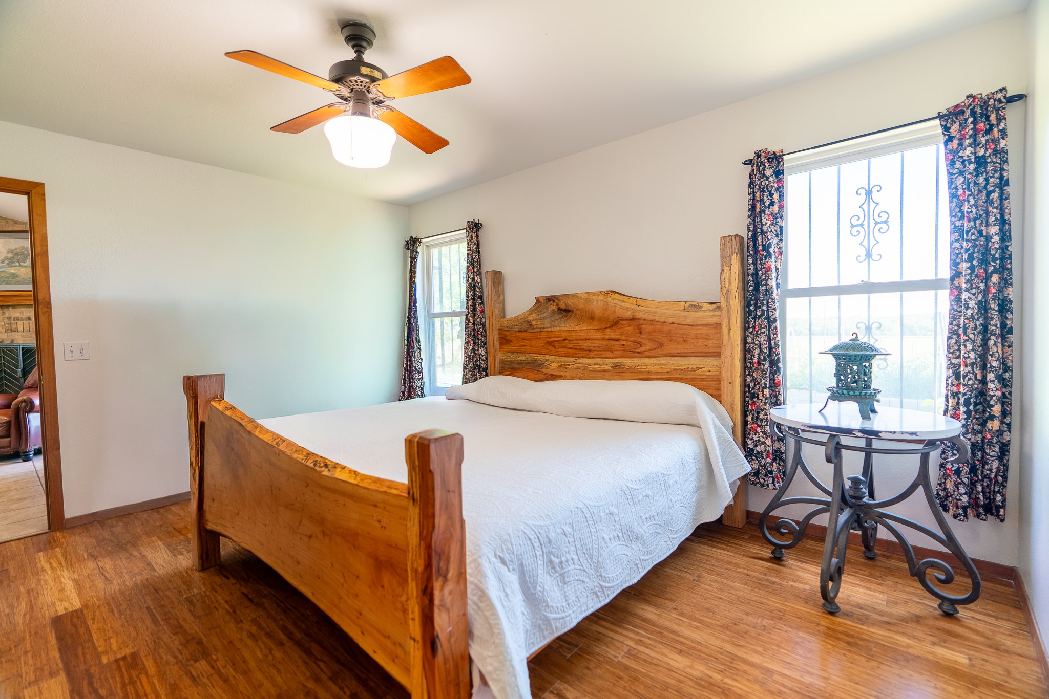400 619th Spur Elgin, TX 78621 - Photo 27 of 40 A well-lit bedroom features hardwood flooring and a stylish ceiling fan.