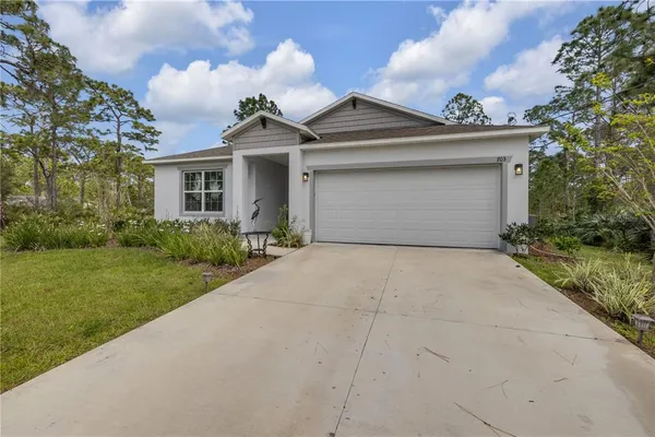 a view of a swimming pool with a yard and sitting area